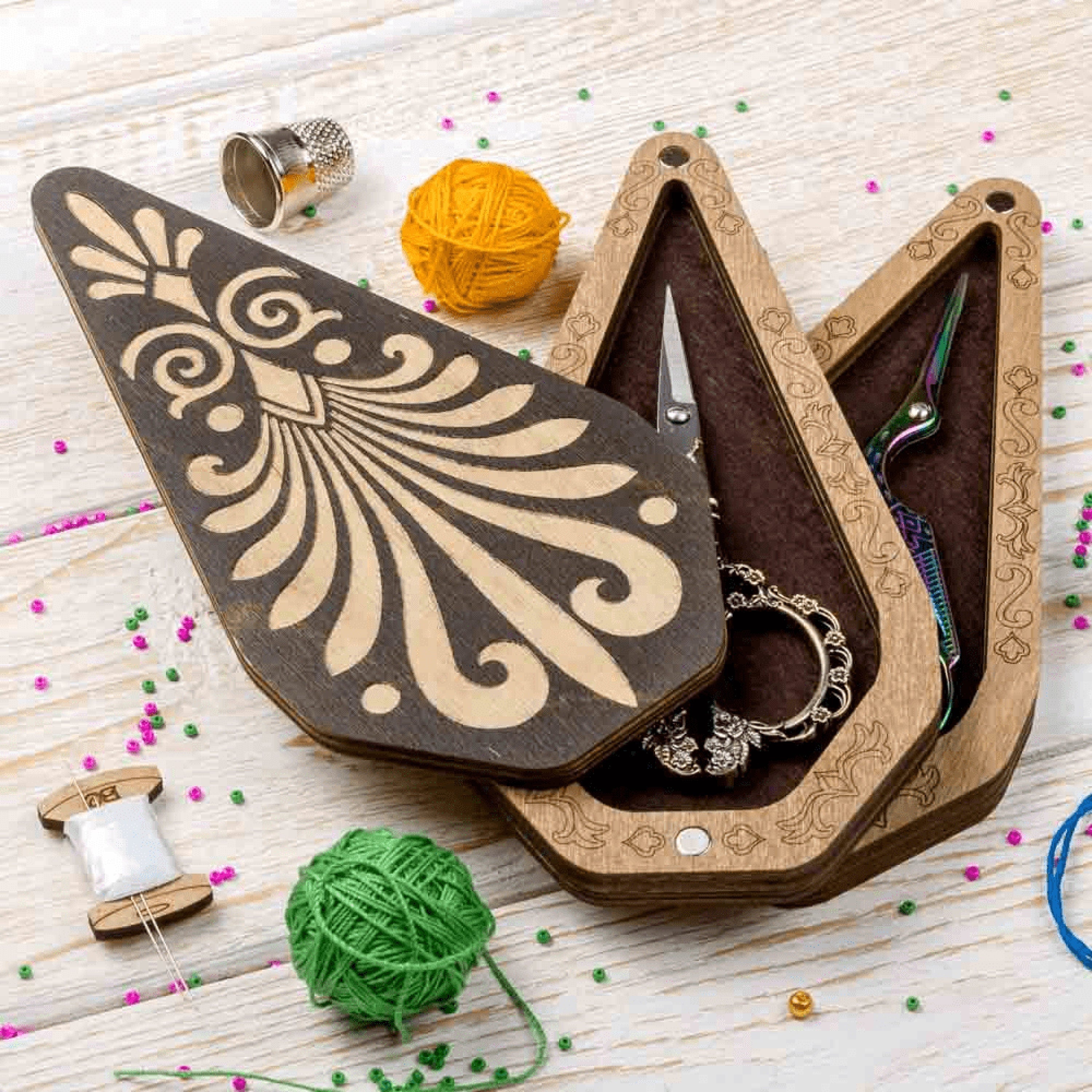 a pair of scissors and a pair of scissors in a wooden box